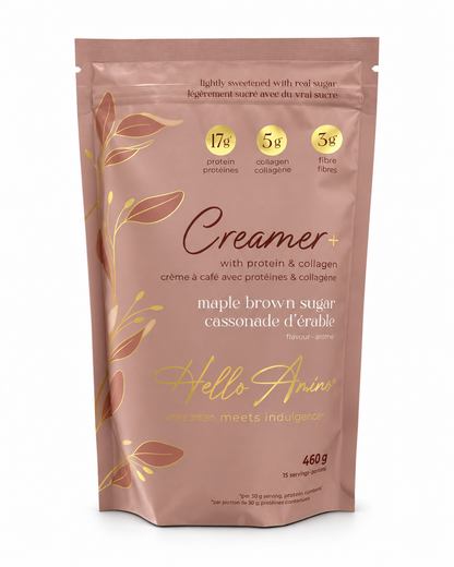 A stand-up pouch of Hello Amino Creamer+ maple brown sugar, featuring a dusty rose-brown background with gold leaf illustrations and yellow circular badges detailing protein, collagen, and fibre content.