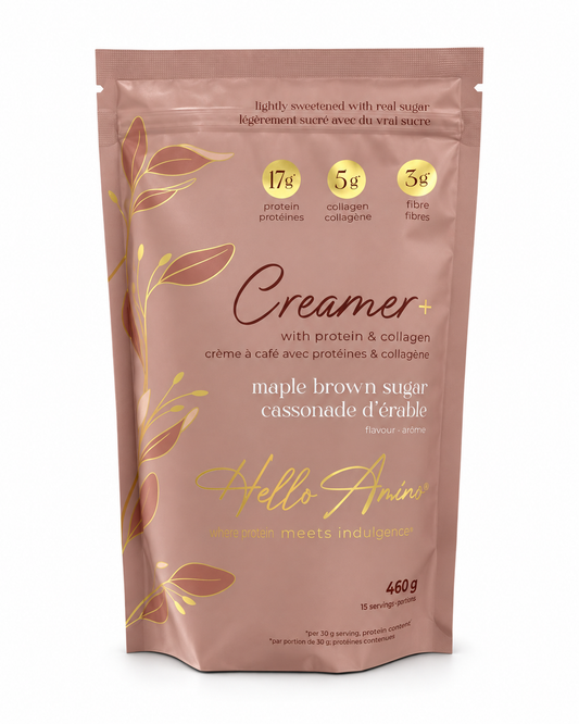 A stand-up pouch of Hello Amino Creamer+ maple brown sugar, featuring a dusty rose-brown background with gold leaf illustrations and yellow circular badges detailing protein, collagen, and fibre content.