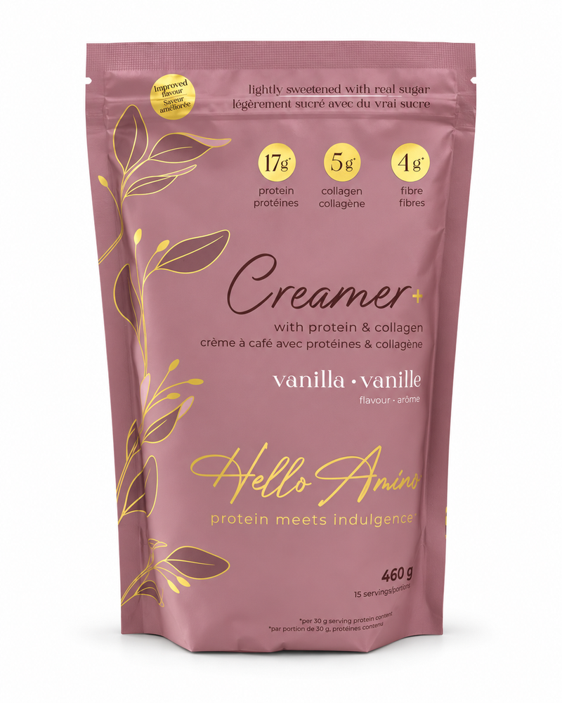 A stand-up pouch of Hello Anime Creamer+ vanilla protein powder. The packaging is a dusty mauve pink with elegant gold foil illustrations of leaves and text highlighting key ingredients and flavor.
