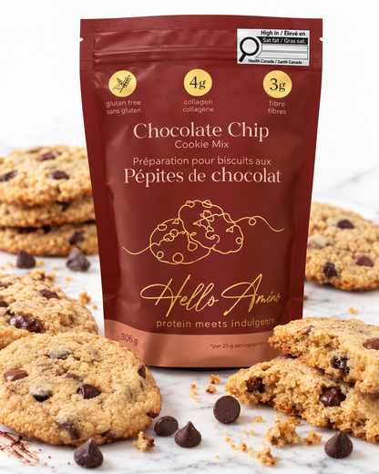 A stand-up pouch of Hello Annie Chocolate Chip Cookie Mix surrounded by chocolate chip cookies on a light marble surface. The pouch is dark reddish brown with gold text and graphics, and the package shows 306g of cookie mix.